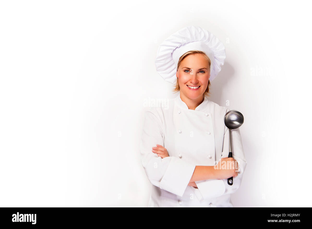 Young woman chef holding ladle, smiling Stock Photo Alamy