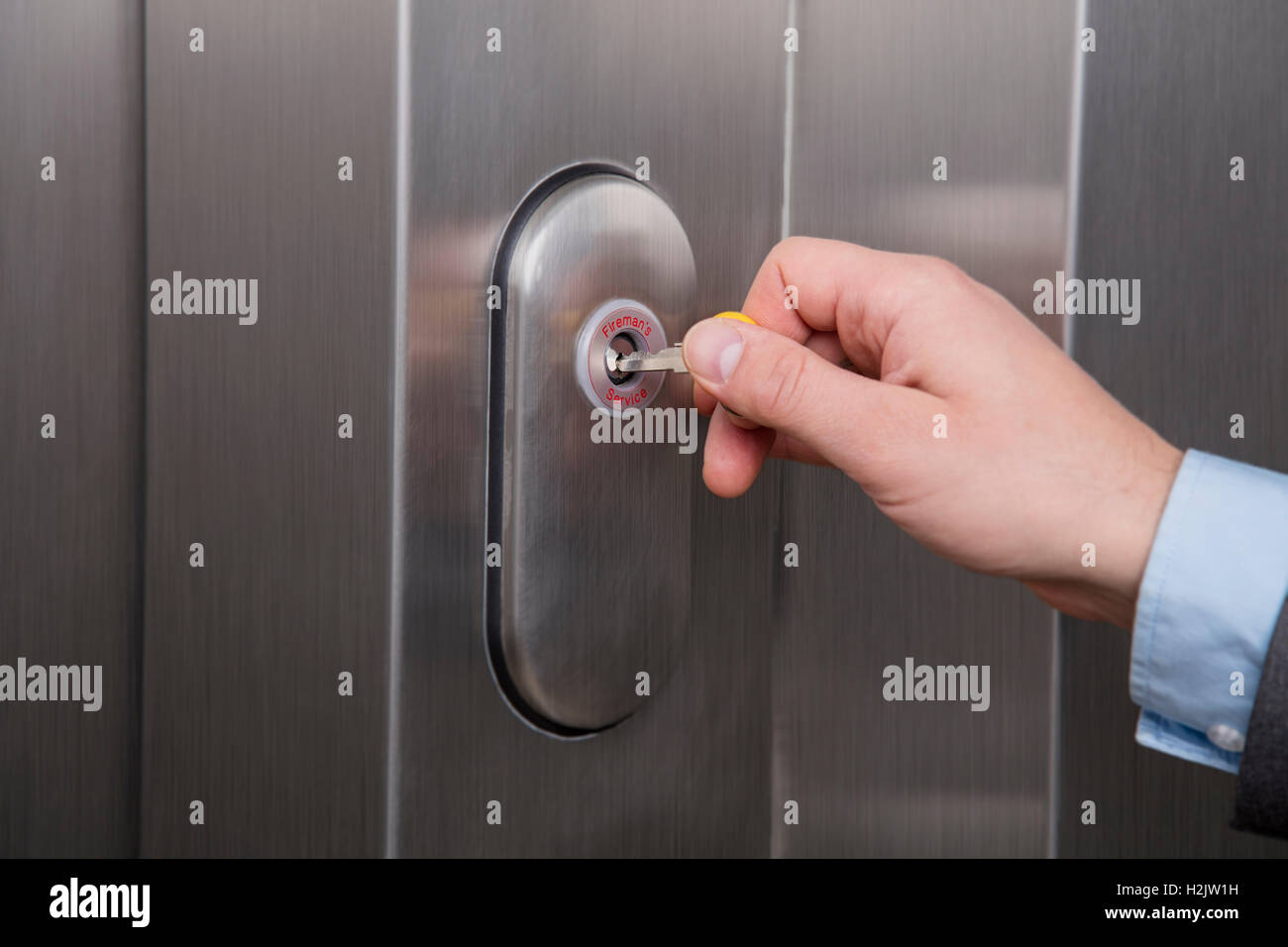 Person unlocking the emergency lock on the elevator Stock Photo Alamy