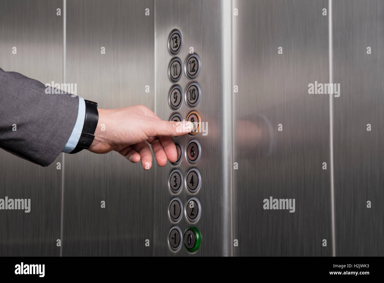 Finger pressing the button in the elevator Stock Photo - Alamy