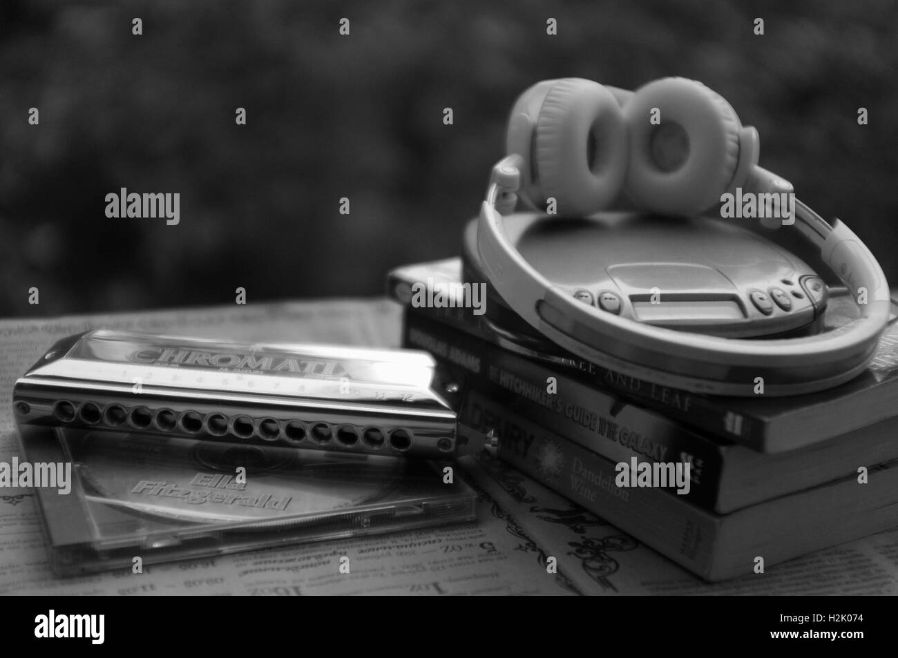 Chromatic harmonica, CD player and books Stock Photo