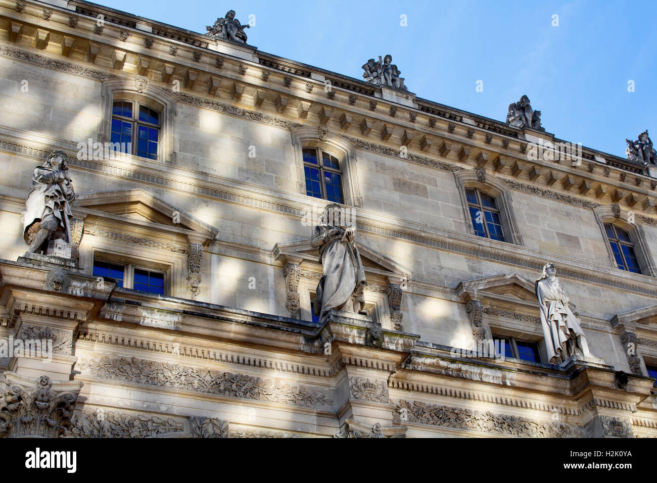 Bottom view of a part of Louvre Museum building on a sunny day in Paris ...