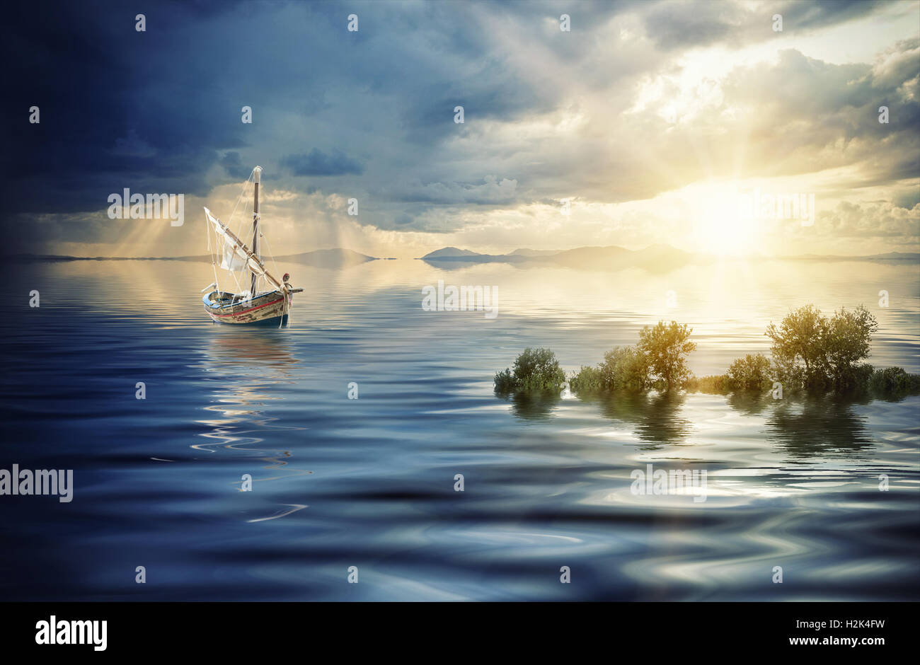 A Fishing boat in the sea at sunset Stock Photo - Alamy