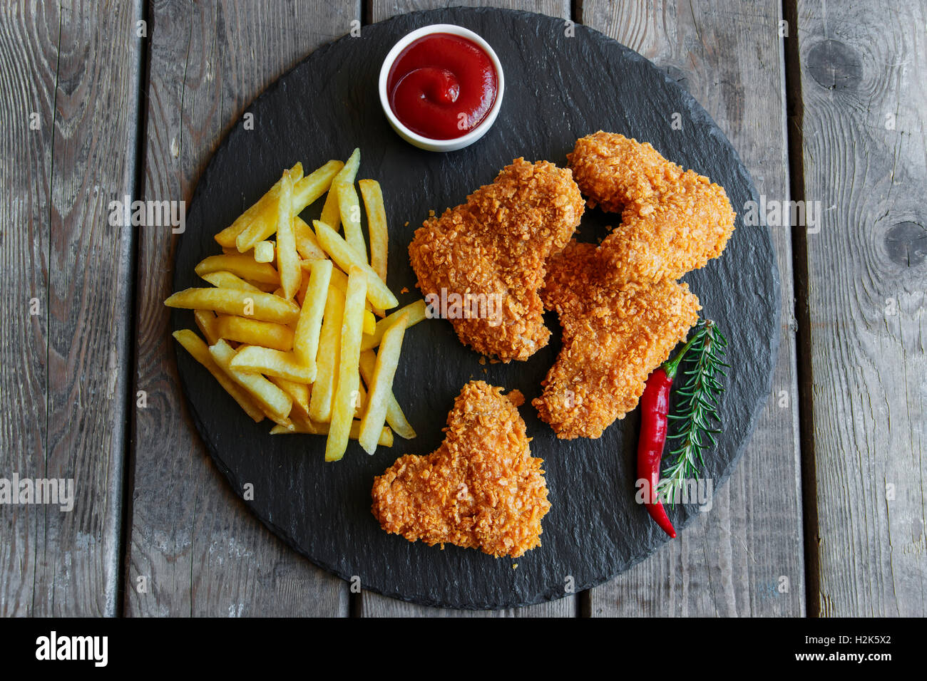 Breaded crispy chicken wing fried french fries sauce Stock Photo