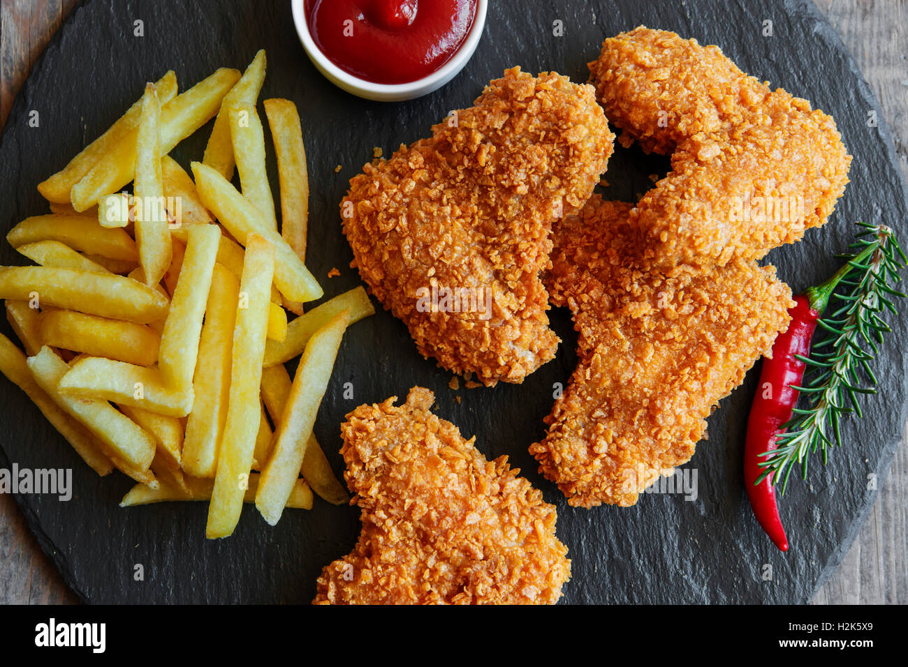 Breaded crispy chicken wing fried french fries sauce Stock Photo