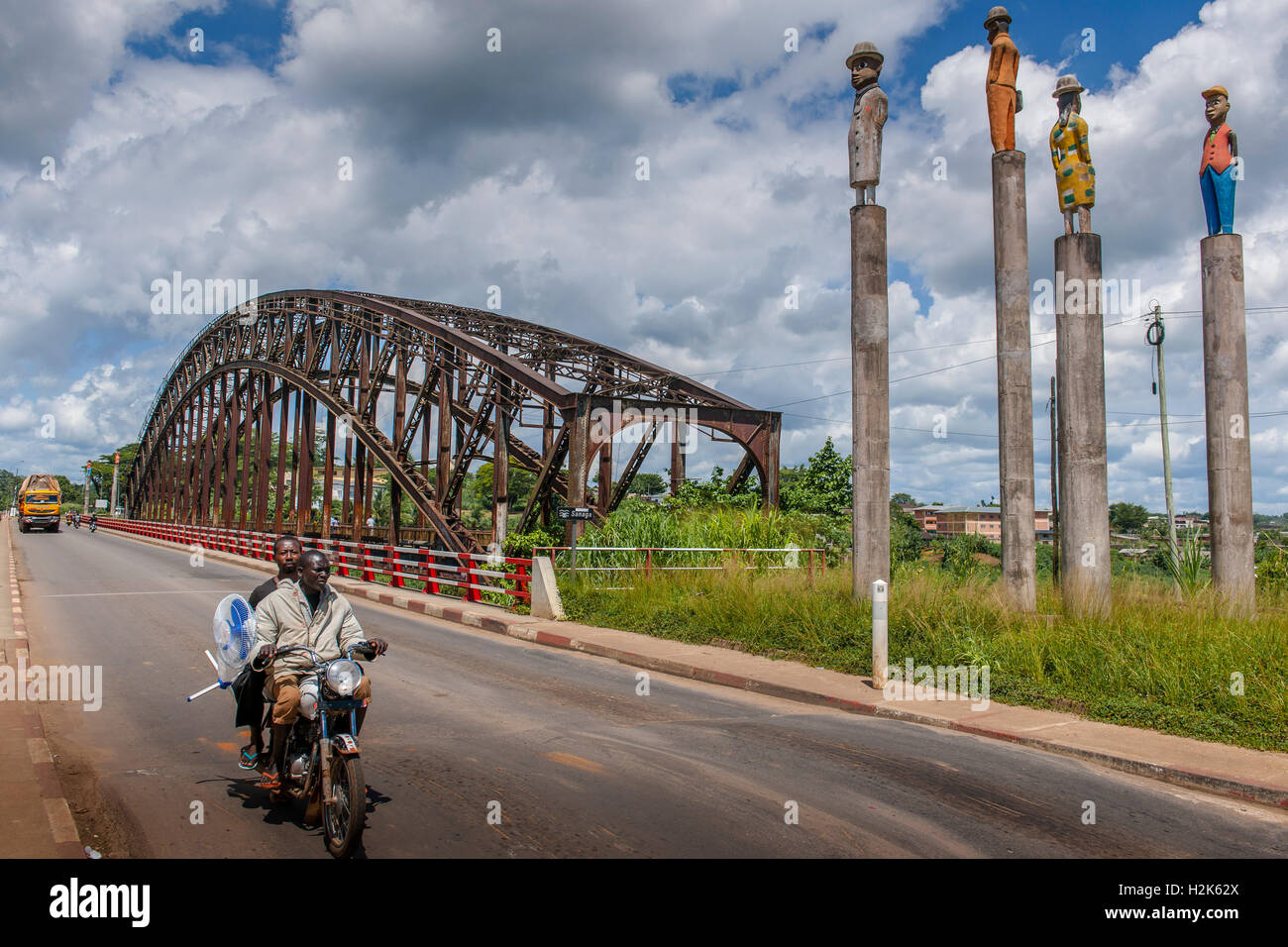Sanaga River, German Colonial Era railway bridge, two men on a motorbike, Edéa, Littoral Region, Cameroon Stock Photo