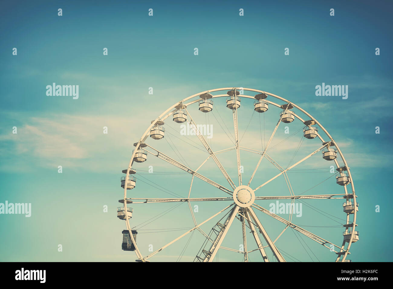 Retro cross processed photo of a Ferris wheel, childhood concept. Stock Photo