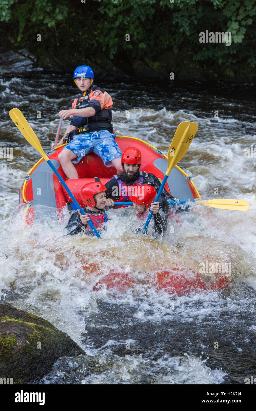 White water rafters getting a good soaking at the National White Water Centre on the River Tryweryn outside Bala North Wales Stock Photo