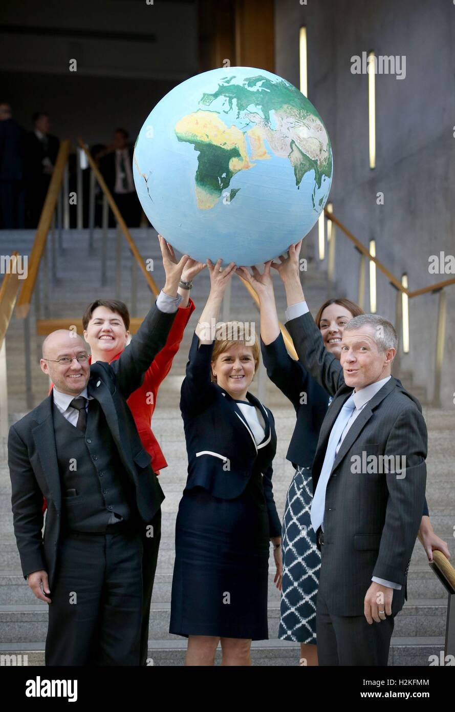 (Left-right) Patrick Harvie, Ruth Davidson, Nicola Sturgeon, Kezia Dugdale and Willie Rennie with a giant model of planet Earth to highlight their commitment to tackle climate change, in the Garden Lobby of the Scottish Parliament, Edinburgh. Stock Photo