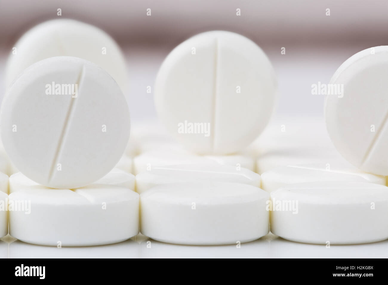 Heap of round white pills and tablets Stock Photo