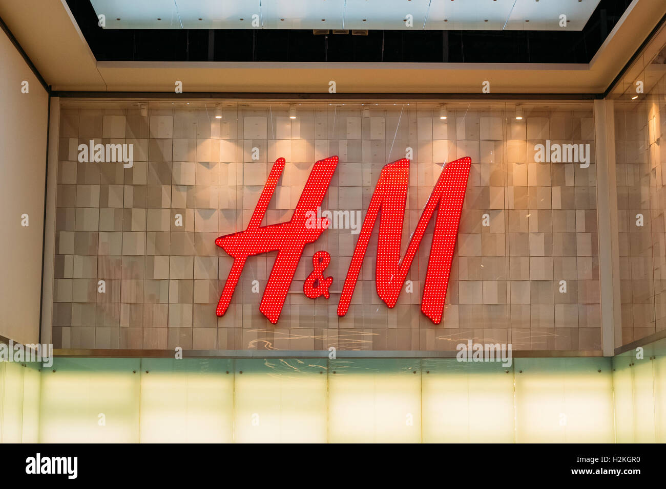 Vilnius, Lithuania - July 08, 2016: Close The Illuminated Red Logotype H&M  Of Hennes & Mauritz Brand At The Gray Wall Of Store I Stock Photo - Alamy