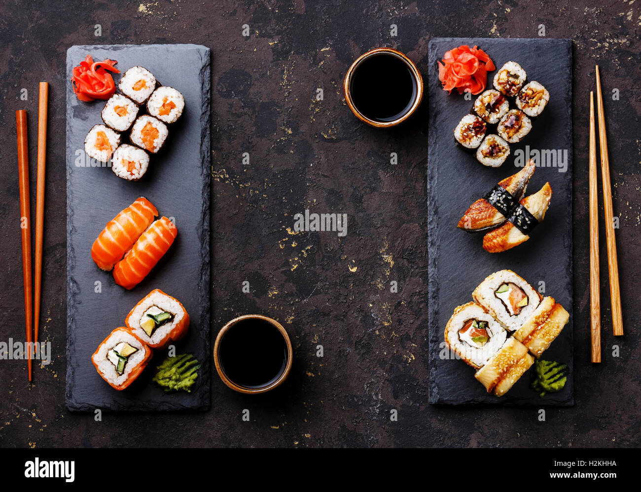 Sushi rolls, maki, nigiri Set served for two on black stone slate on dark background copy space Stock Photo