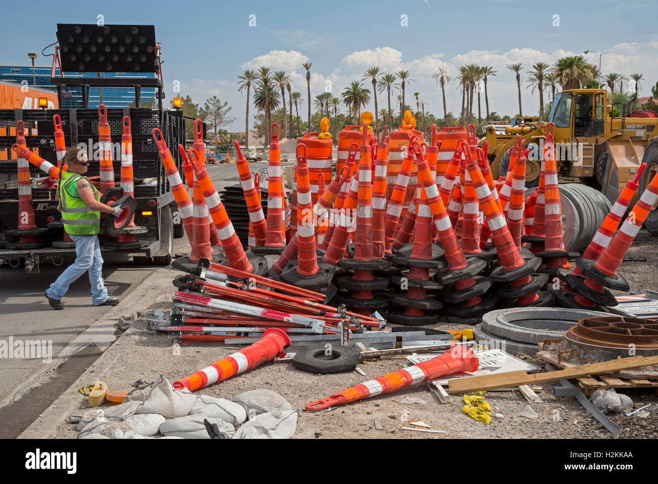 Las Vegas, Nevada - A worker stacks traffic barriers at a road construction site. Stock Photo