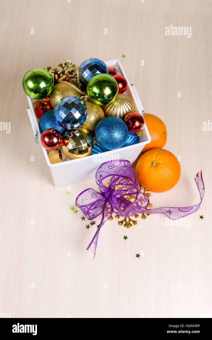 Christmas decorations lay in a white box that is on the table Stock