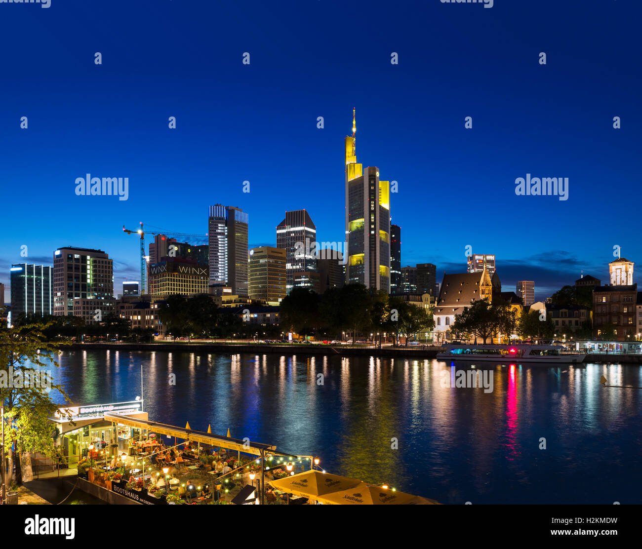 Frankfurt skyline. View from Eiserner Steg towards the Financial District with the Bootshaus floating restaurant in foreground, Frankfurt, Germany Stock Photo