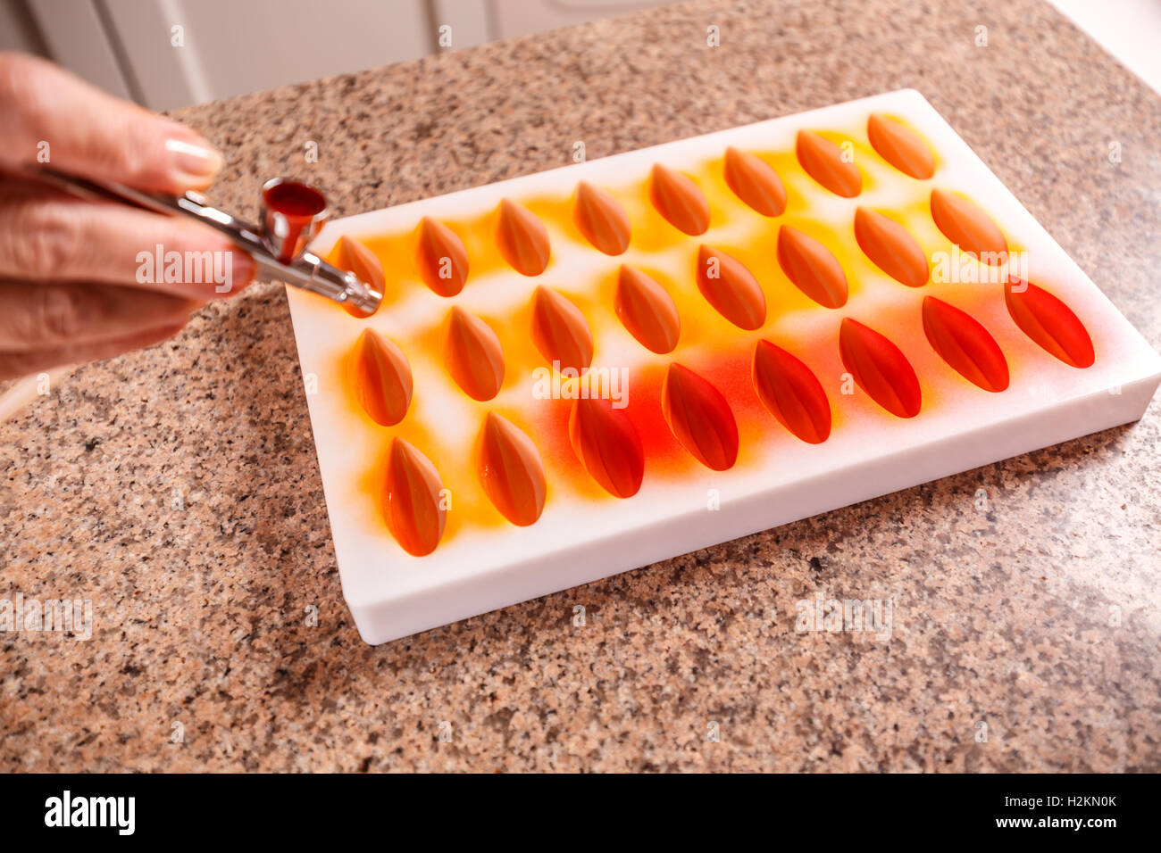 Making chocolate candies in mold Stock Photo Alamy