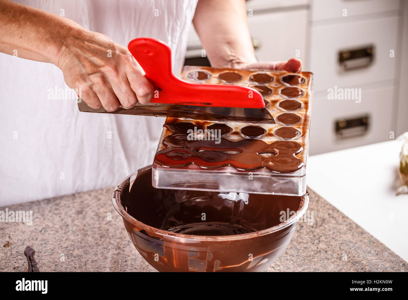 Making chocolate candies in mold Stock Photo Alamy