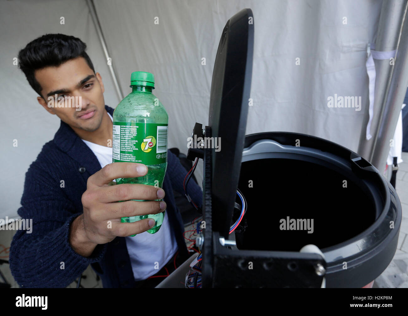 (160929) -- VANCOUVER, Sept. 29, 2016 (Xinhua) -- A graduate student of Simon Fraser University shows an intelligent garbage bin which can sort out different garbage by reading barcodes during the Greater Vancouver Clean Technology Expo in Vancouver, Canada, Sept. 28, 2016. About 40 companies and graduate students from Simon Fraser University showcased their latest innovations in clean technology during the expo. (Xinhua/Liang Sen) (zw) Stock Photo