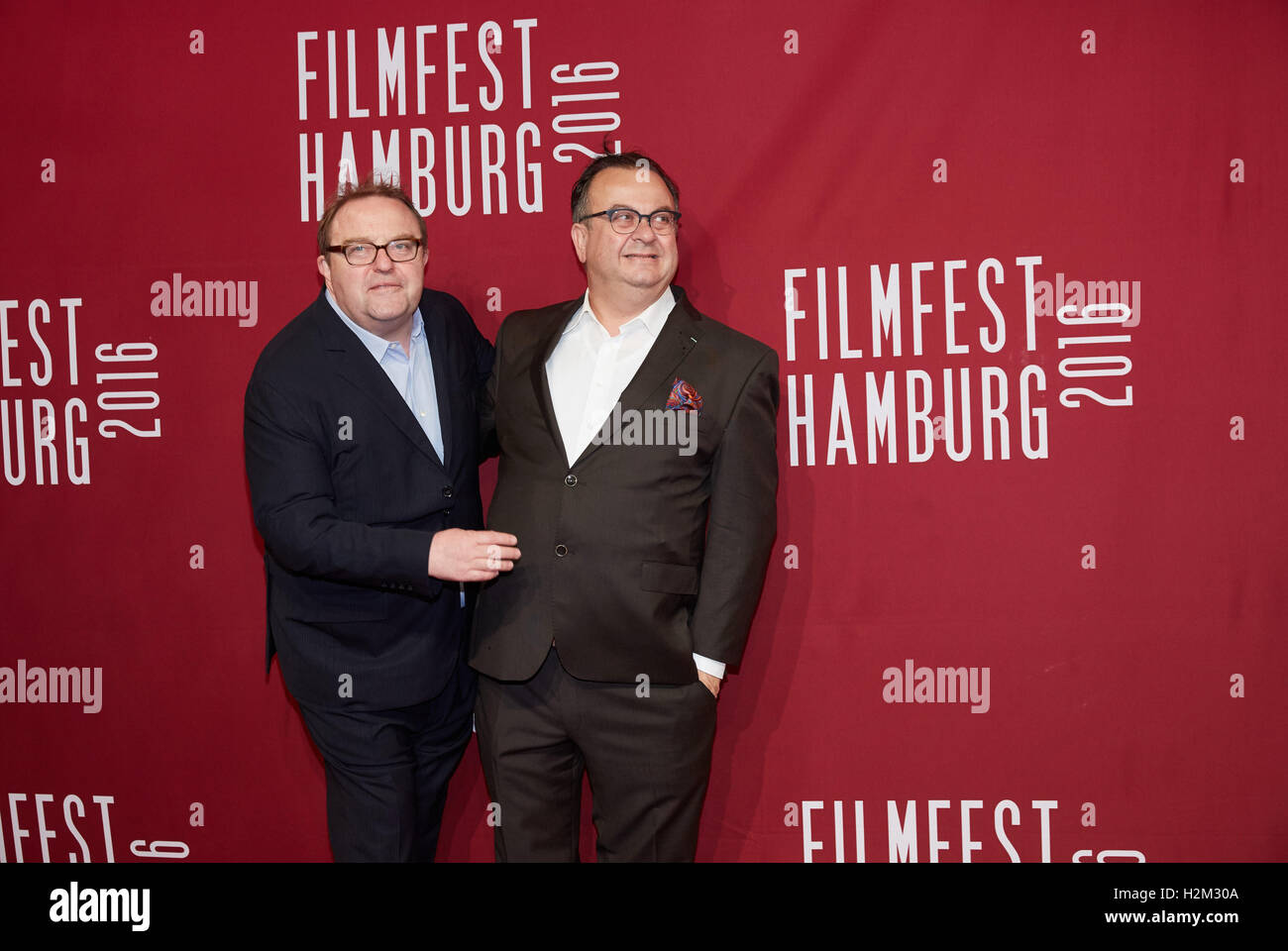 Hamburg, Germany. 29th Sep, 2016. Festival director Albert Wiederspiel (R)and his life partner, the actor Gustav Peter Woehler, arrive to the opening of the 24th Filmfest at the CinemaxX-Dammtor in Hamburg, Germany, 29 September 2016. Photo: GEORG WENDT/dpa/Alamy Live News Stock Photo