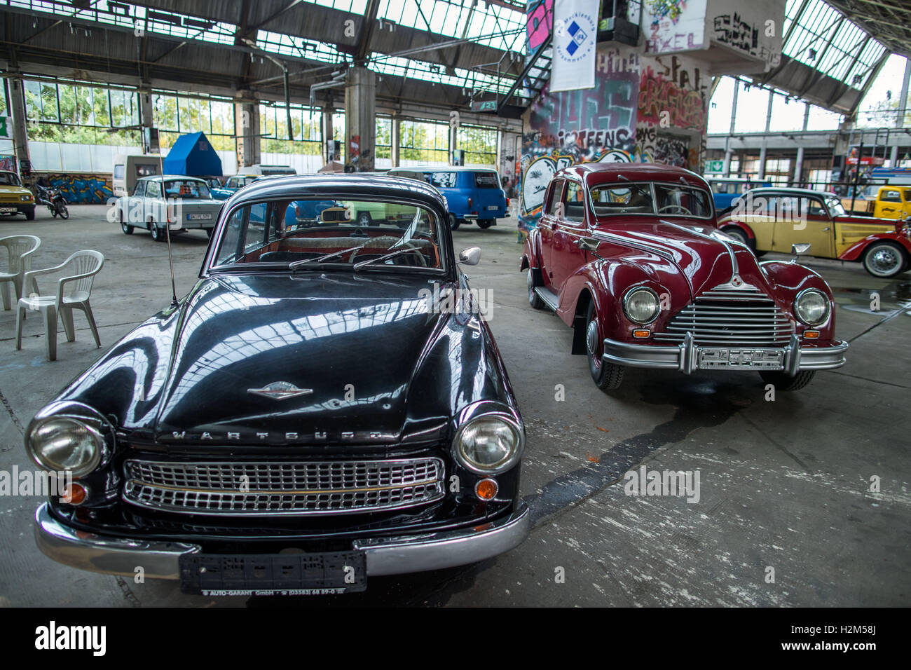 Schwerin, Germany. 30th Sep, 2016. A 311 Wartburg and an EMW 340 from the Fahrzeugfabrik Eisenach stand in an exhibition hall at the former vehicle maintenance factory 'Fortschritt' in Schwerin, Germany, 30 September 2016. The association 'IFA Mecklenburg-Western Pomerania', which was wounded in 1997, has organised the 10th oldtimer meeting for vehicles from the former GDR. More than 1000 historical vehicles came to the state capital in the last years. PHOTO: JENS BUTTNER/dpa/Alamy Live News Stock Photo
