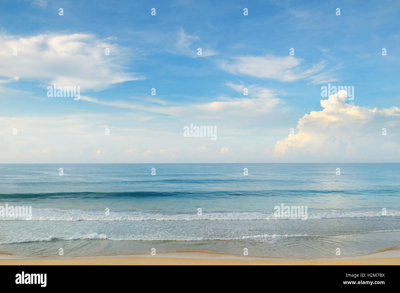 ocean, sandy beach and blue sky Stock Photo - Alamy