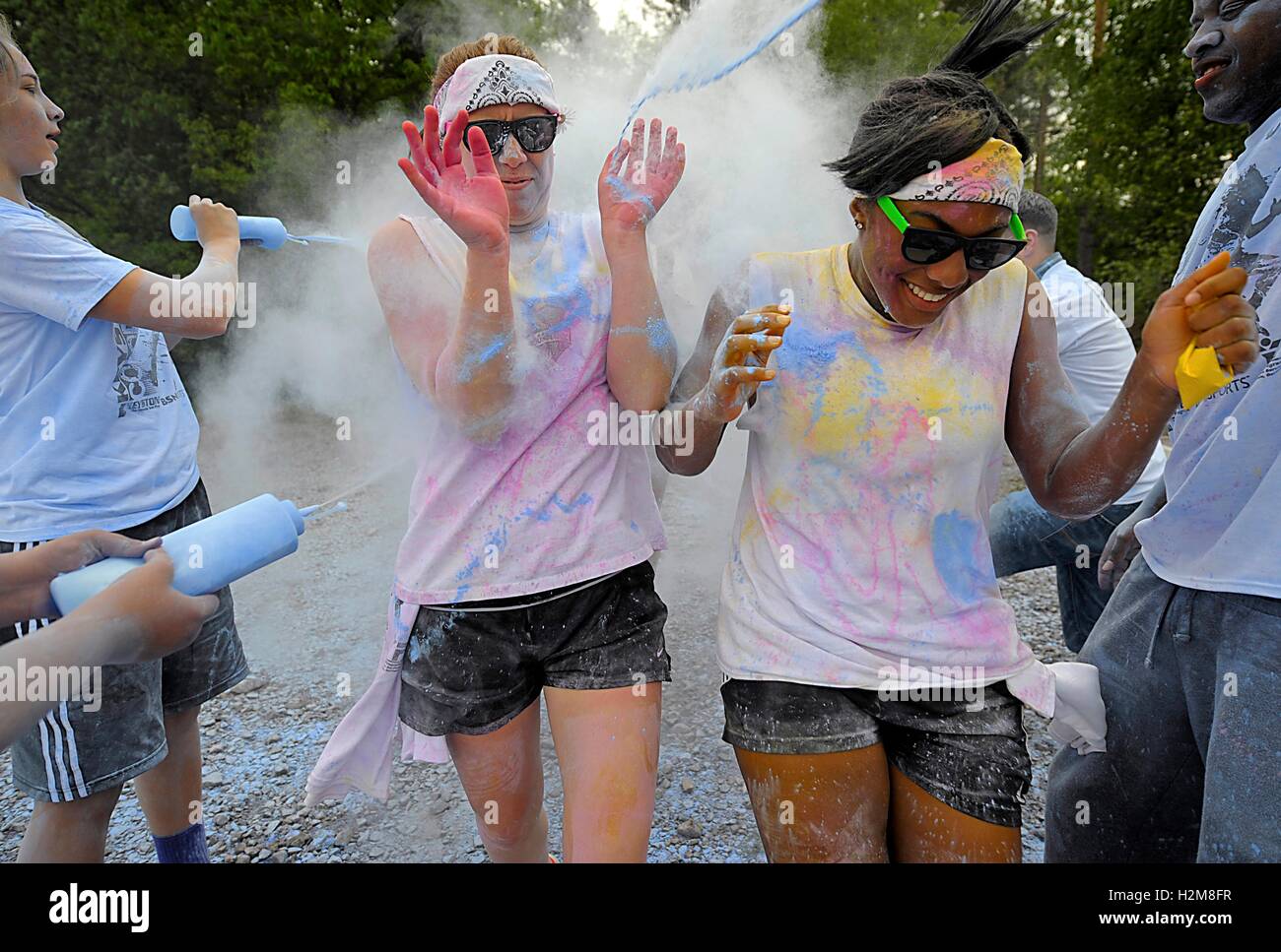 Runners are sprayed with colored powder during the Keystone Color Run at the Ramstein Air Base May 10, 2014 in Ramstein-Miesenbach, Germany. Stock Photo