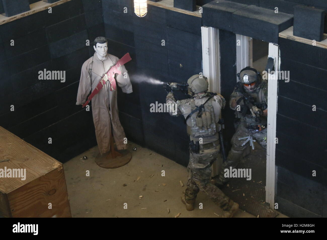 U.S. special forces commandos shoot at a target dummy during a live