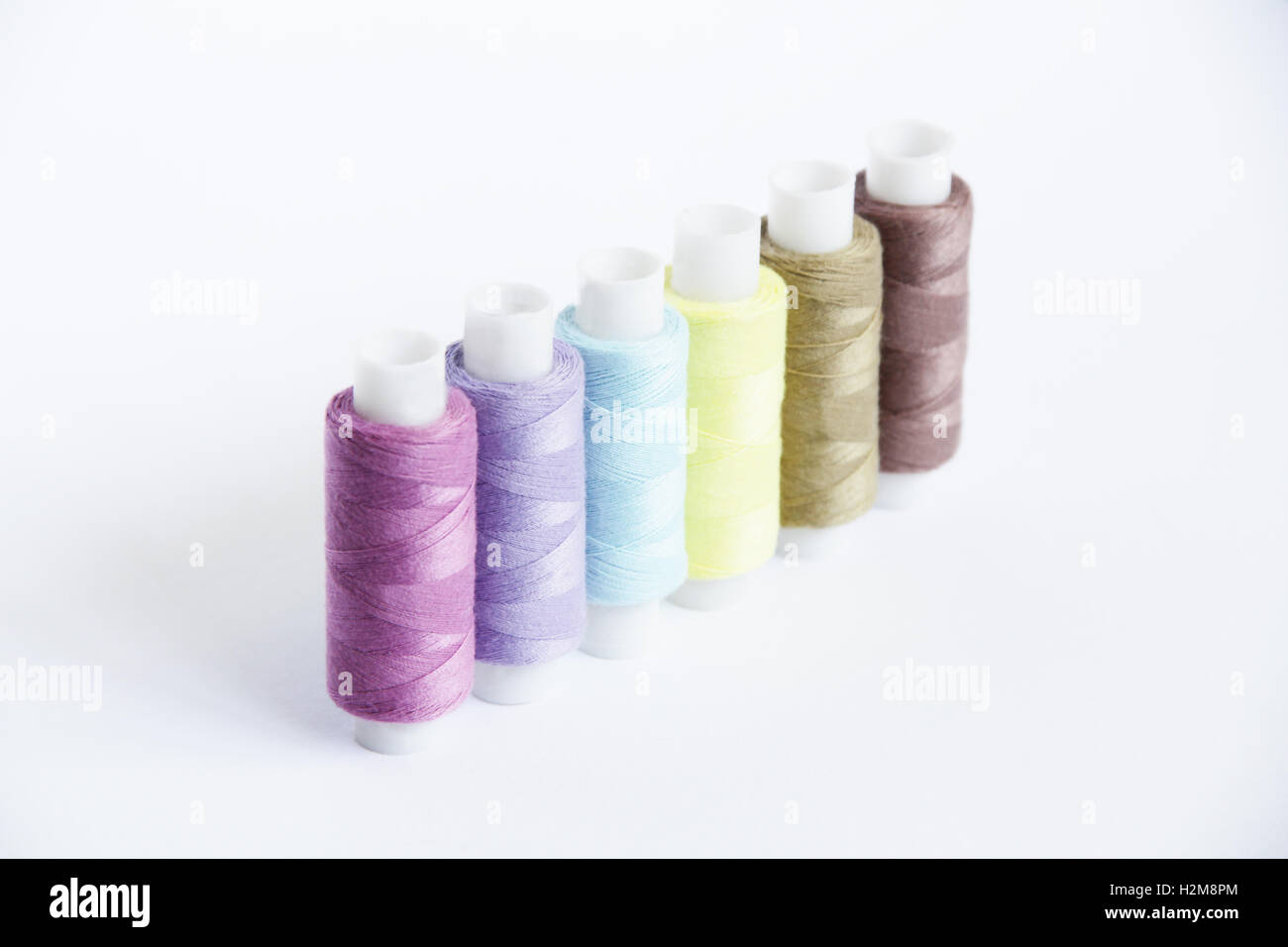 Sewing threads of different colors in beautiful pattern Stock Photo - Alamy