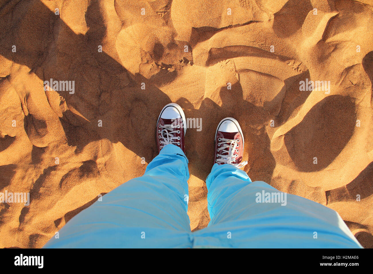 Dubai desert sand close up with read sneakers Stock Photo