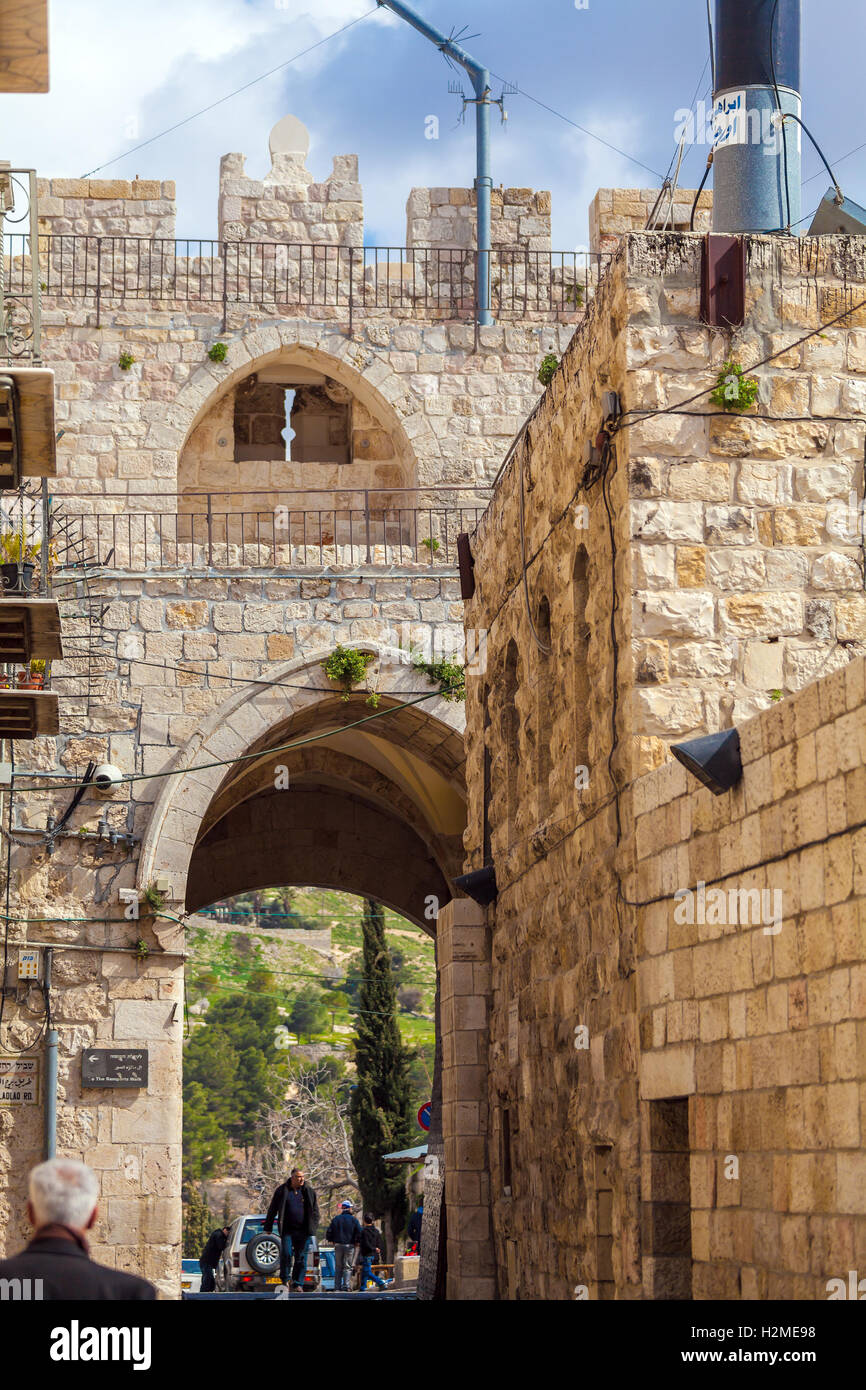 JERUSALEM, ISRAEL - FEBRUARY 16, 2013: Tourists walking near Lions gate of old city Stock Photo