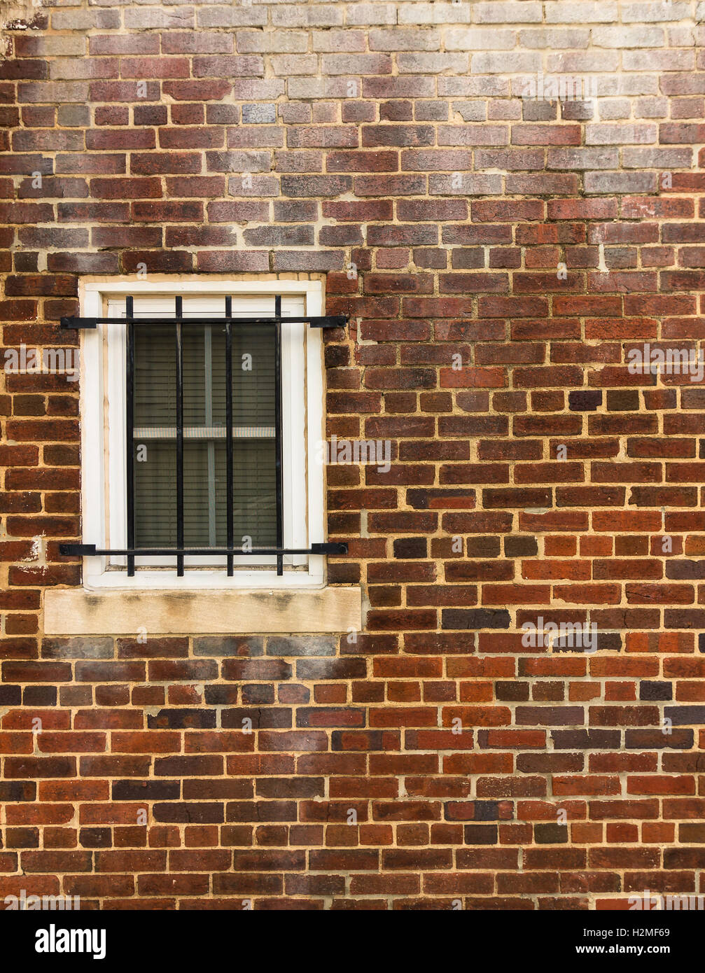 Weathered brick wall with a barred window Stock Photo - Alamy
