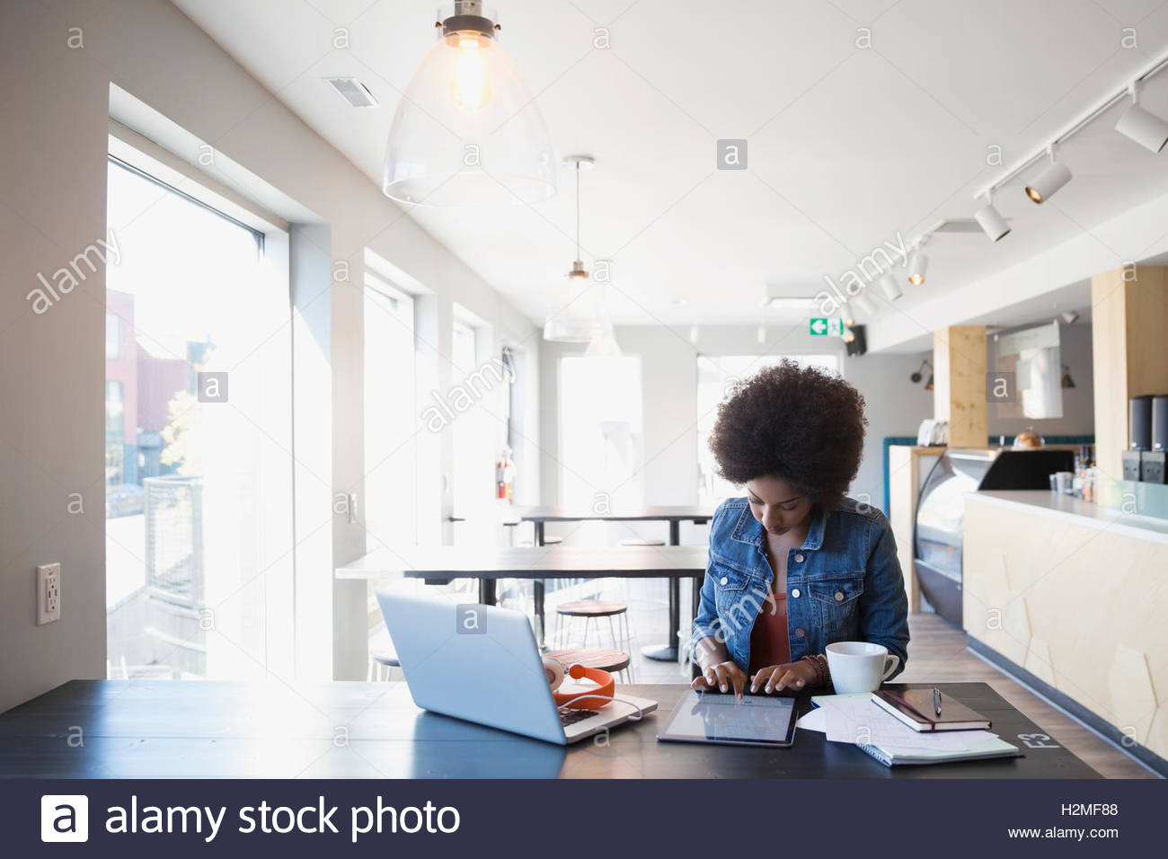 Woman working at digital tablet in cafe Stock Photo