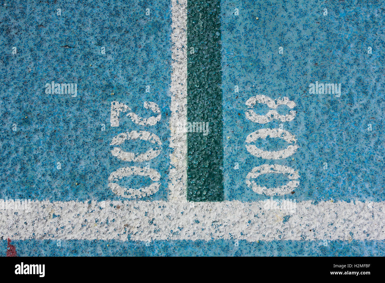 Measurement numbers on a blue all-weather running track.   1600, 3200, 10000 meters. Stock Photo