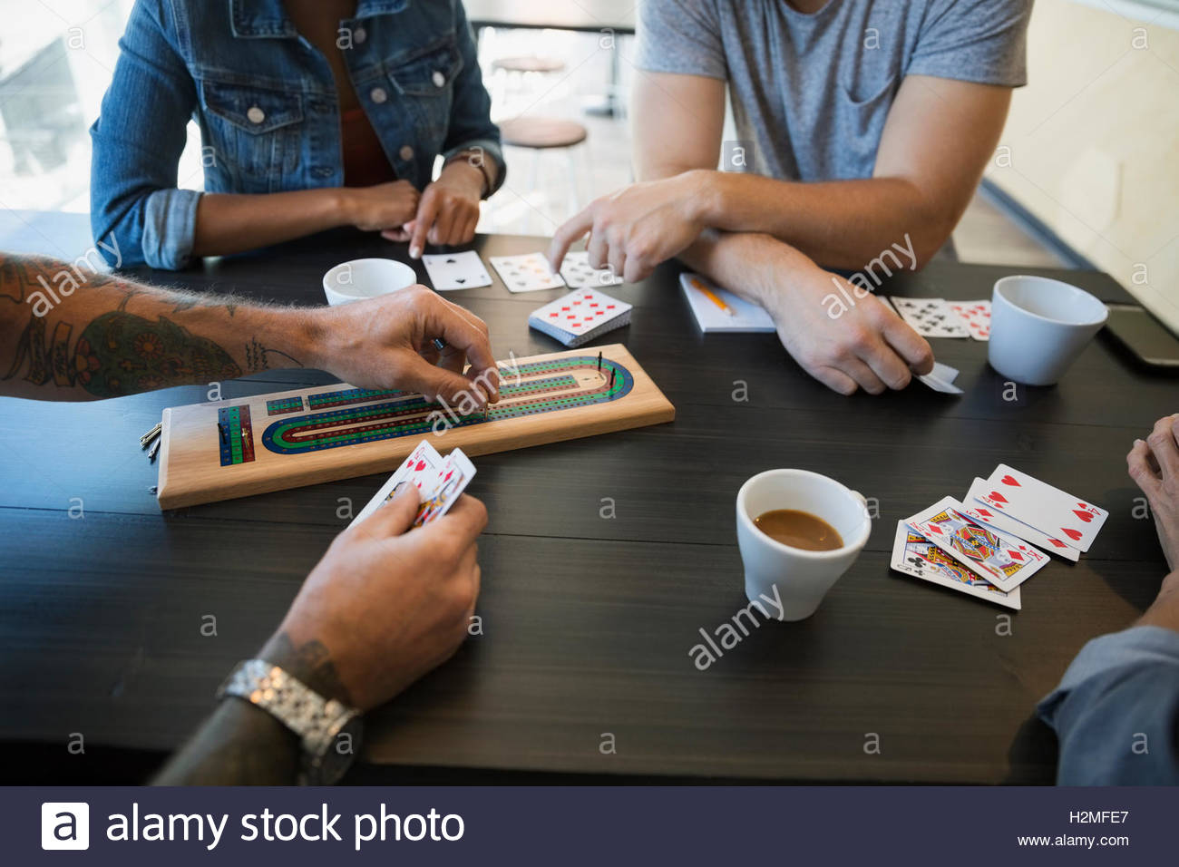 Friends playing cribbage game at cafe Stock Photo Alamy