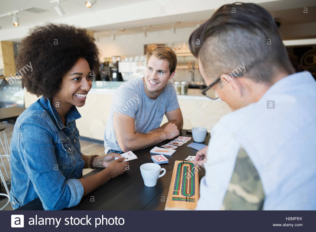 Friends playing cribbage game at cafe Stock Photo Alamy