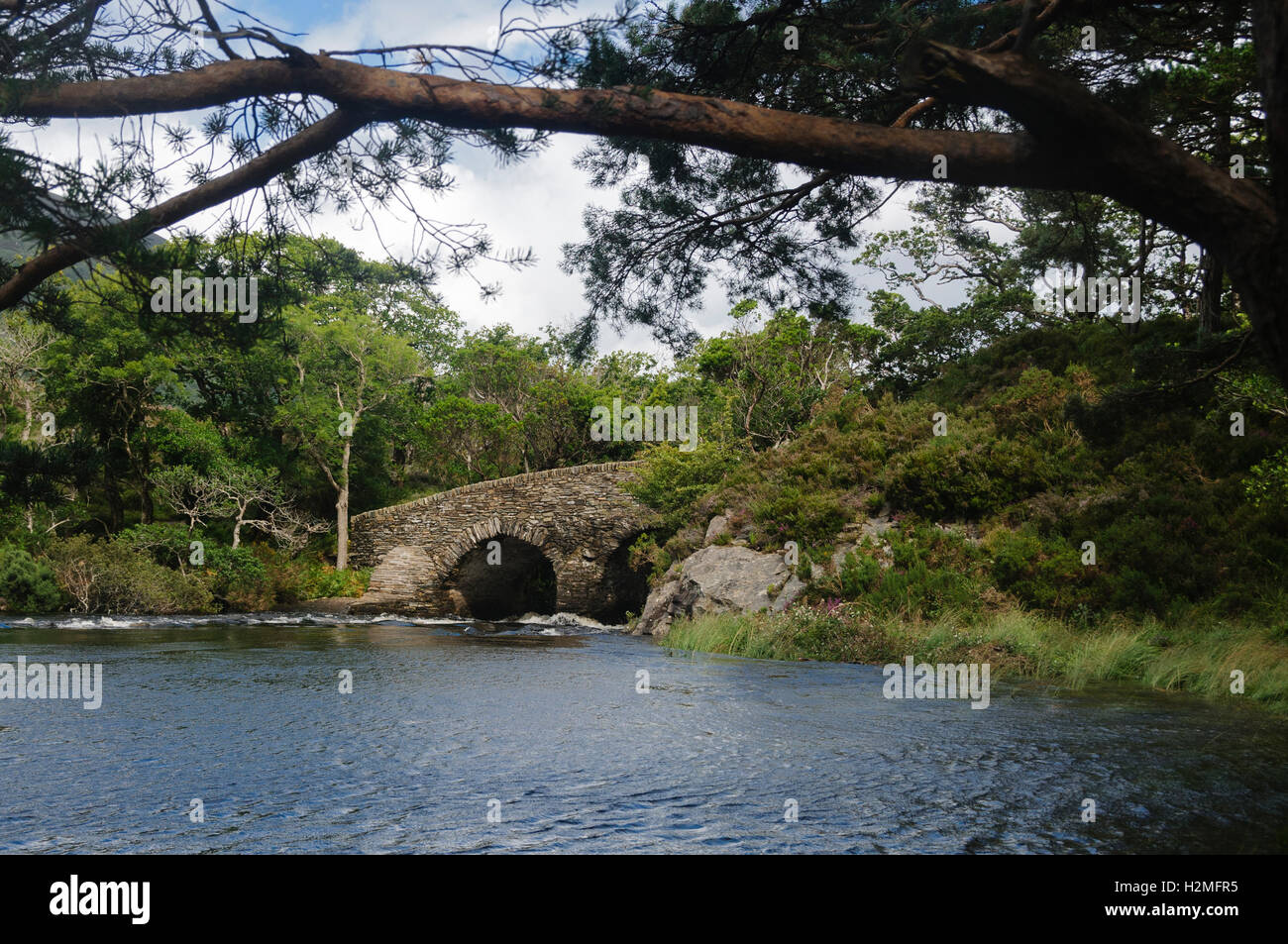 Meeting of the water: a stone bridge between Lough Leane (Lower Lake) and Upper Lake in Killarney National Park, Ireland, Europe Stock Photo