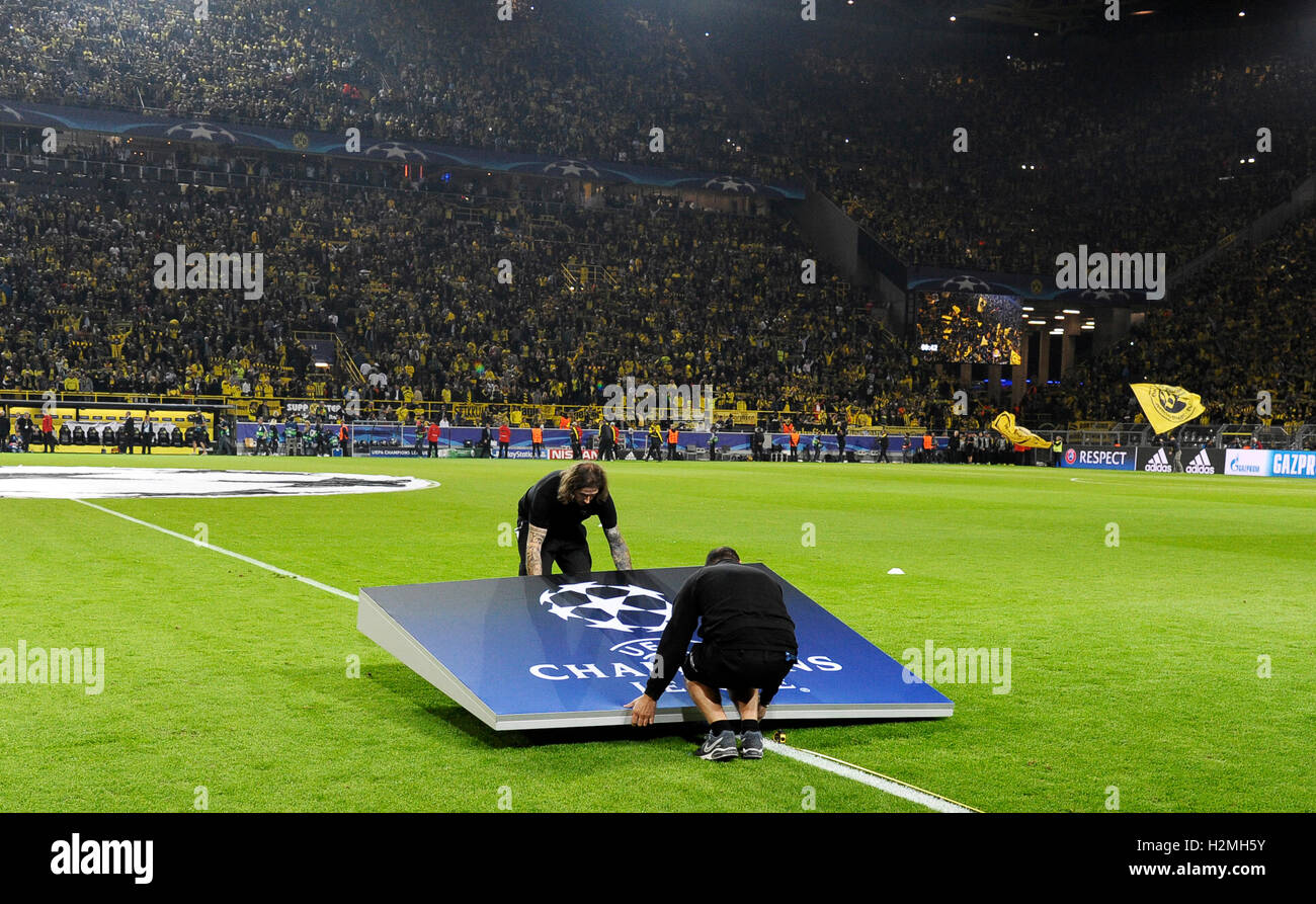 Signal-Iduna Arena Dortmund Germany , 27.9.2016, UEFA Champions League Season 2016/17, Group stage, matchday 2 - Borussia Dortmund (BVB) vs. Real Madrid --- workers position the Champions League logo on the pitch Stock Photo