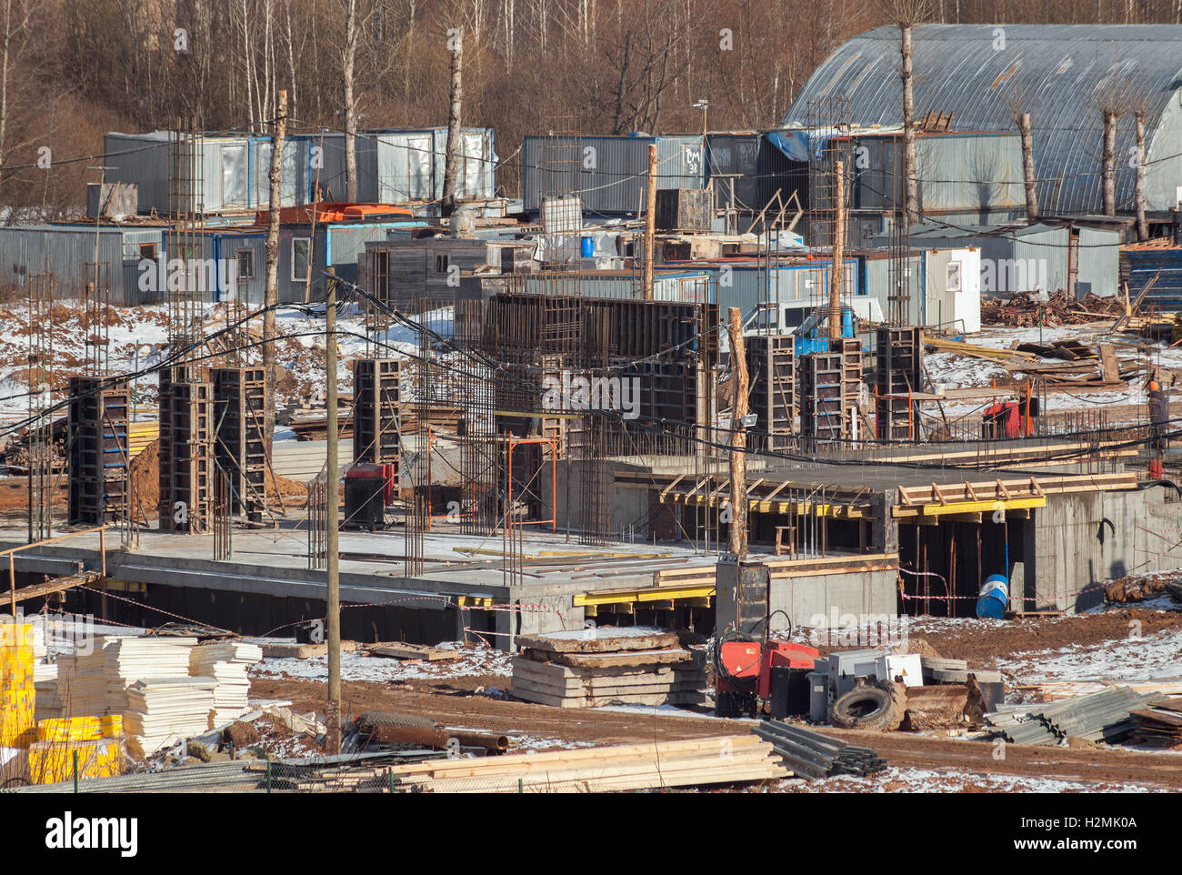 The construction site of the future apartment house in the winter. Construction of the first floor. Installing formwork. Stock Photo
