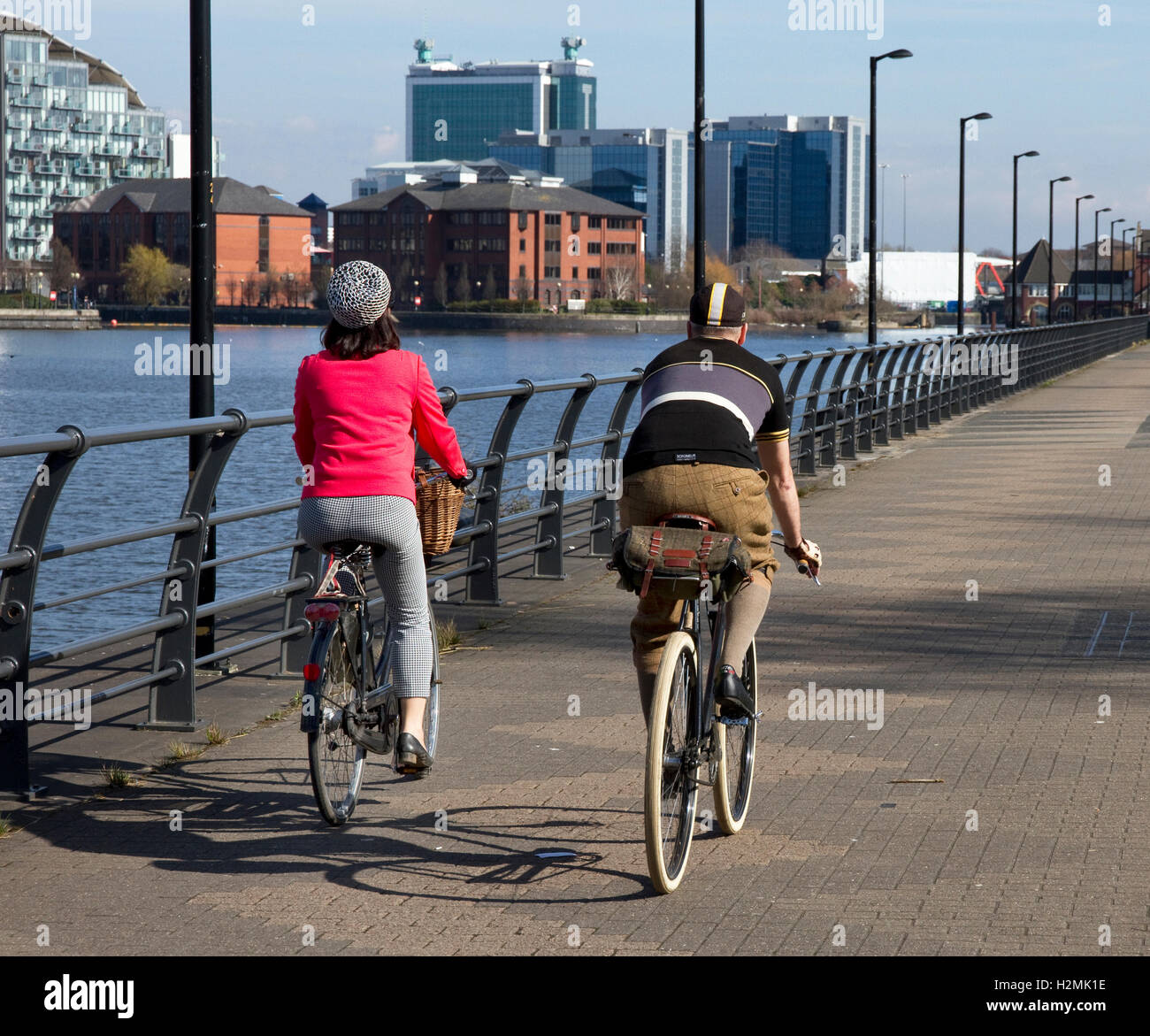 Cyclists ( vintage style) riding along Trafford Wharf , Salford Quays, Salford / Manchester, UK Stock Photo