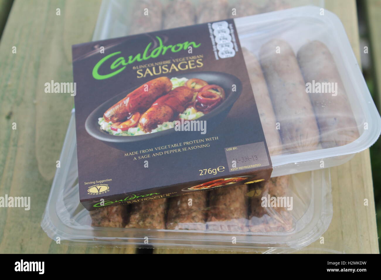 Pack of vegetarian Cauldron sausages on a picnic table outside