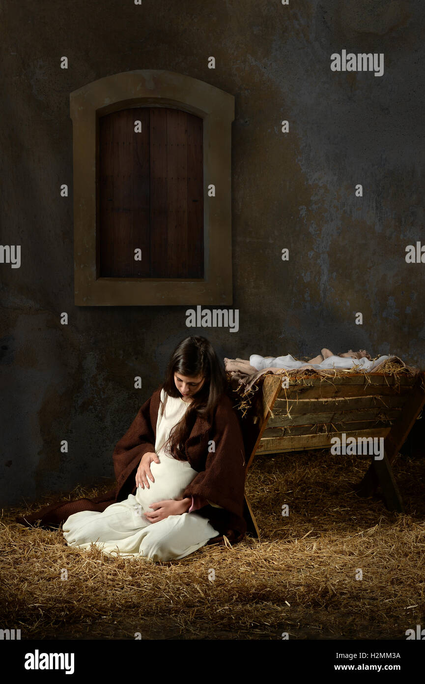 Pregnant Mary and the manger on Christmas Eve Stock Photo