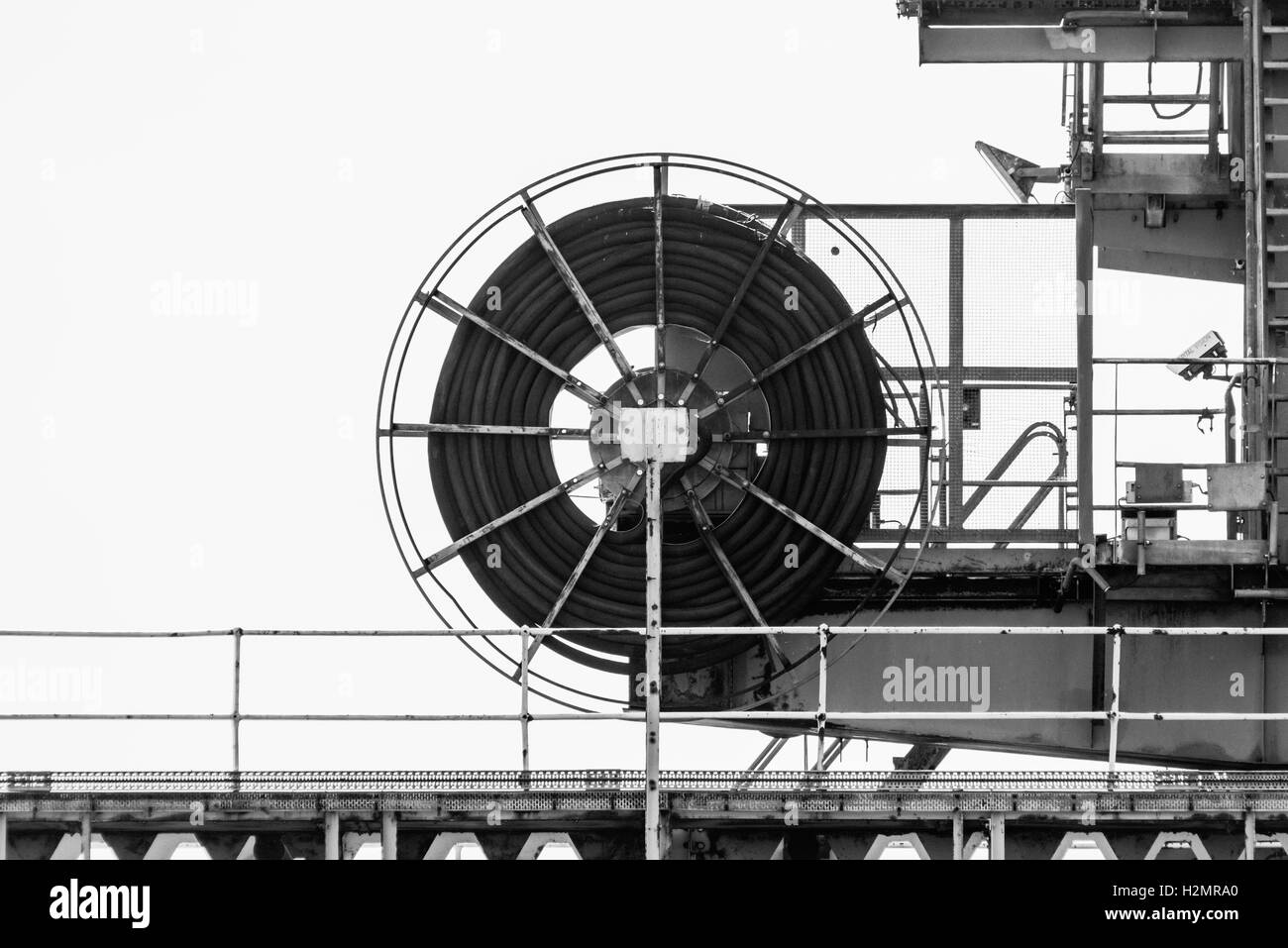 A black and white shot of a hose on the jetty of the disused Tilbury B Power Station Stock Photo