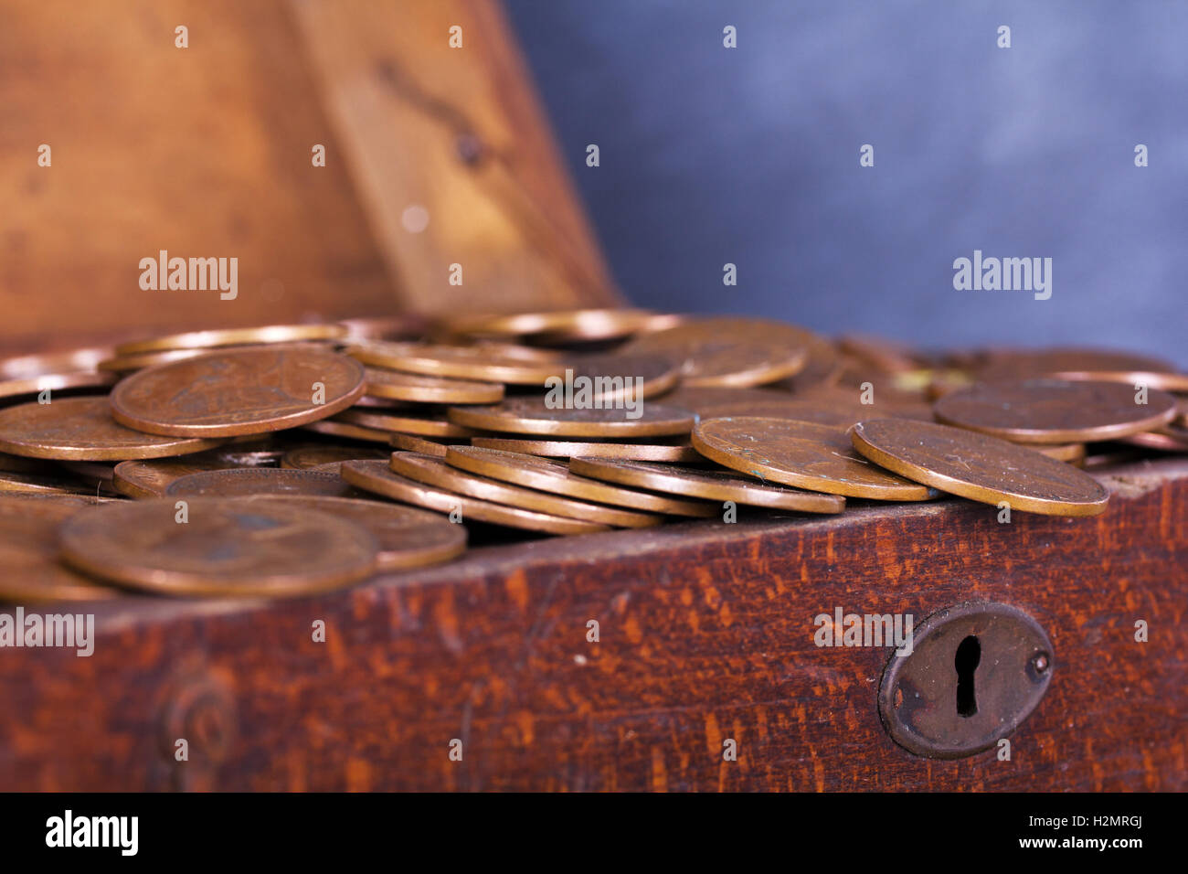 Old wooden chest filled with old copper coins Stock Photo Alamy