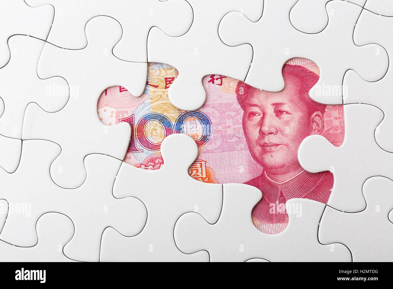 Incomplete puzzle over chinese yuan banknote background Stock Photo