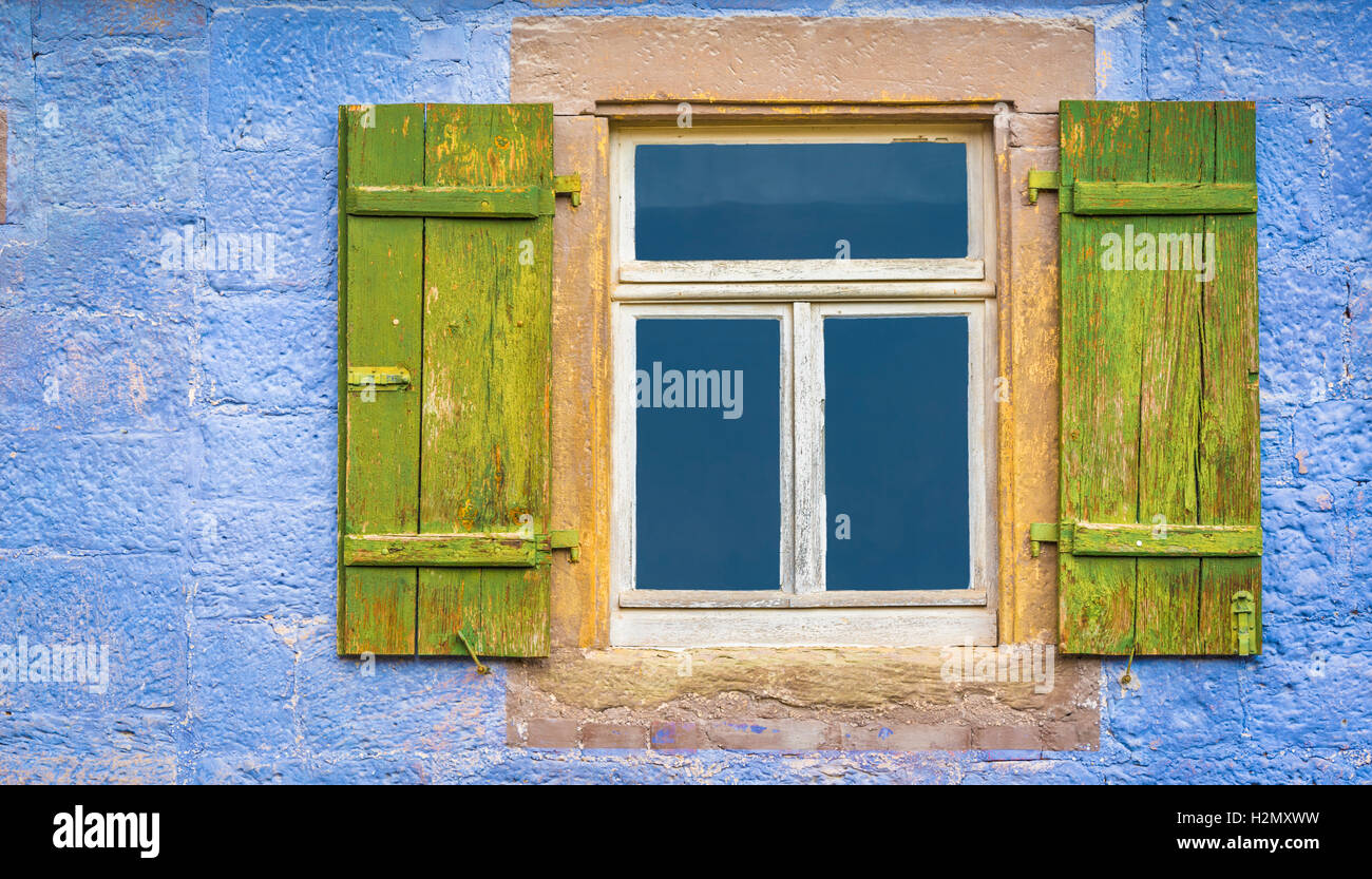 Aged wooden window and green shutters from an old german house with ...