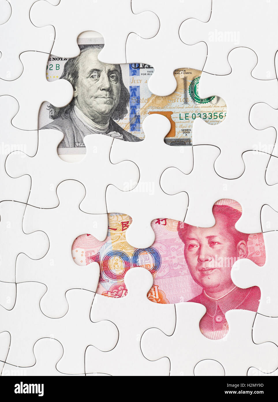 US dollar and chinese yuan with white puzzle Stock Photo