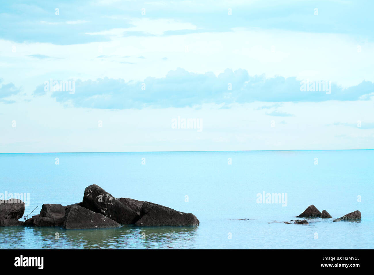Aqua blue waters with rocky foreground Stock Photo