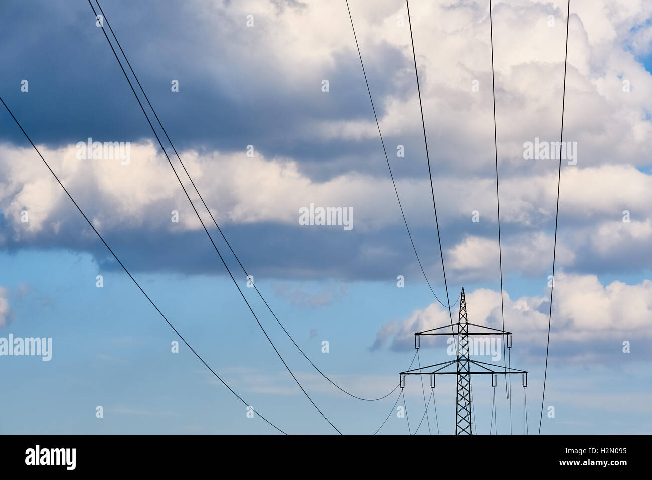 High voltage transmission grid with vivid blue sky and clouds Stock ...