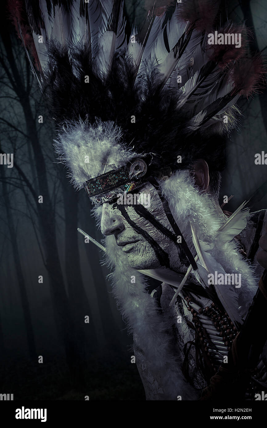 American Indian chief of the tribe. man with feather headdress a Stock Photo