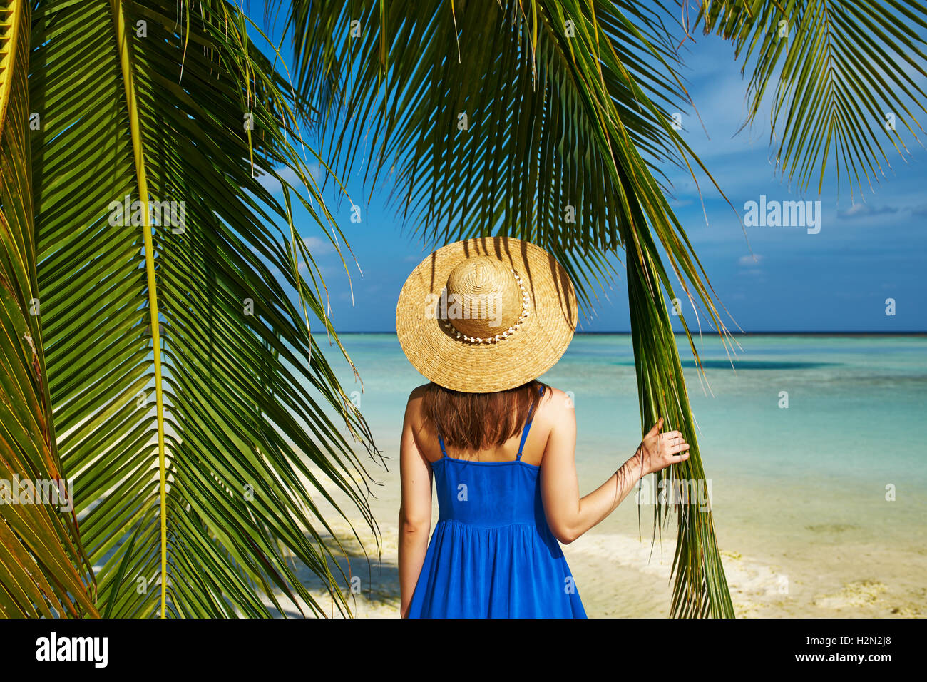 Woman in blue dress on a beach at Maldives Stock Photo Alamy