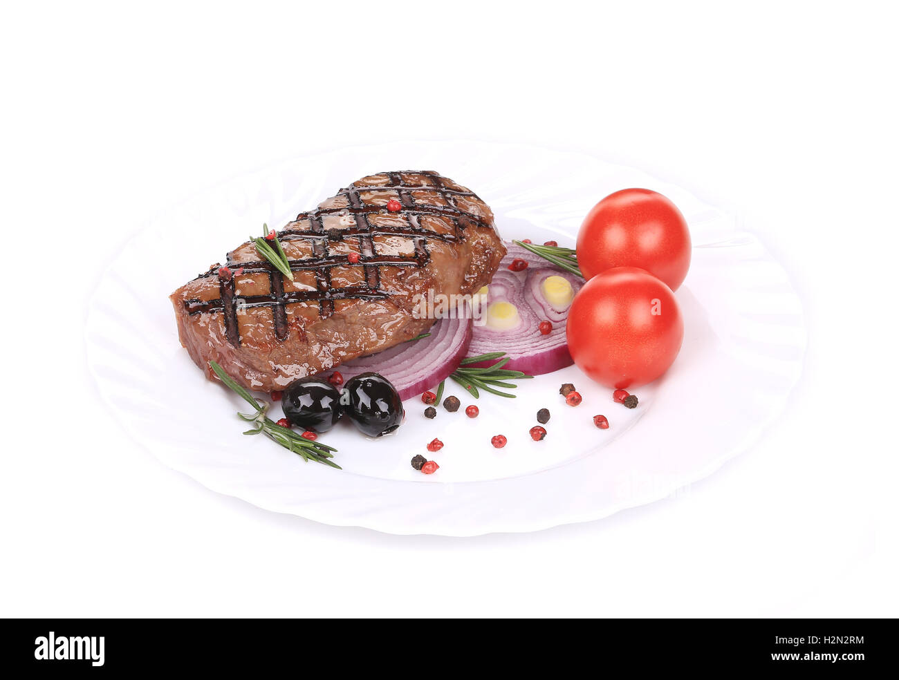 Big juicy grilled steak with greens. Stock Photo